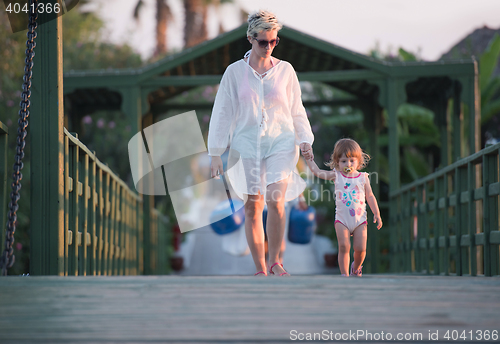 Image of girl and mother walking