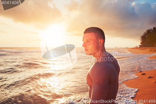 Image of Athletic man on the tropical beach