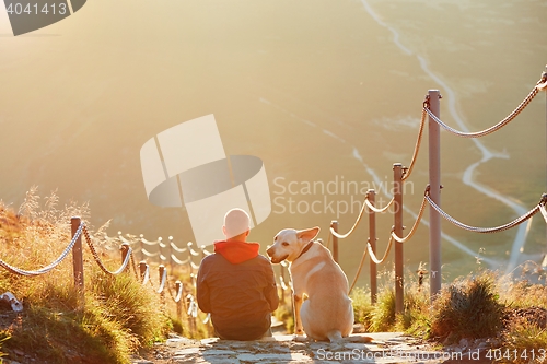 Image of Man with dog on the trip in the mountains