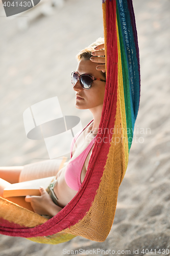 Image of relaxed woman laying in hammock