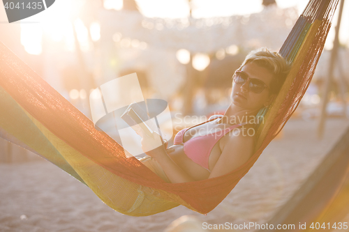 Image of relaxed woman laying in hammock