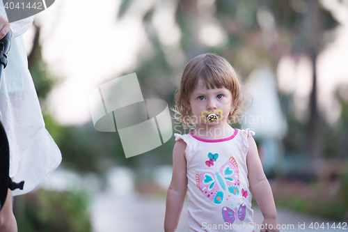 Image of girl and mother walking