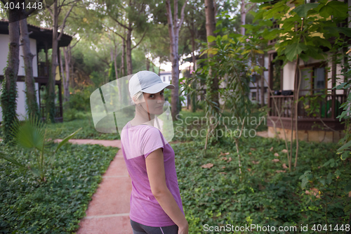 Image of woman  stretching before morning jogging