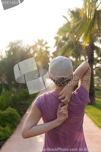 Image of woman  stretching before morning jogging