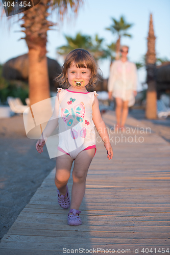 Image of girl and mother walking
