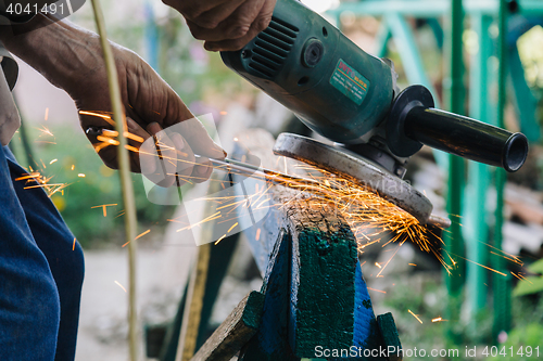 Image of Close-up of workman working with iron