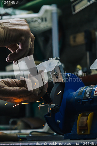 Image of Close-up of workman working with iron