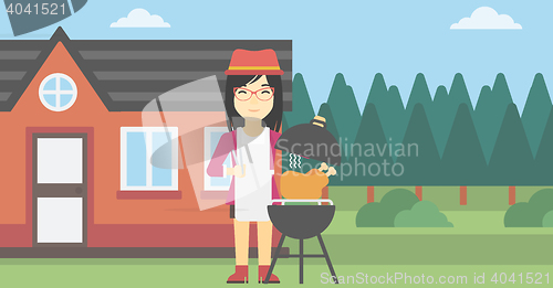 Image of Woman cooking chicken on barbecue grill.