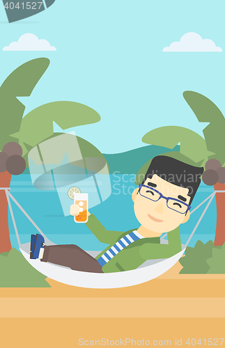 Image of Man chilling in hammock with cocktail.