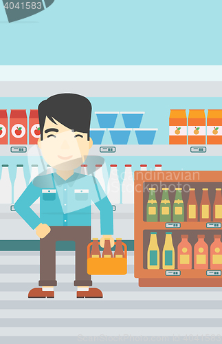 Image of Man with pack of beer at supermarket.