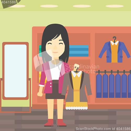 Image of Woman holding dress with jacket.