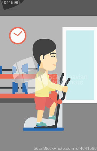 Image of Man exercising on elliptical trainer.