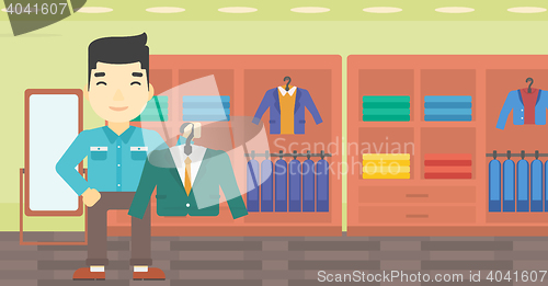 Image of Man holding suit jacket in clothing store.