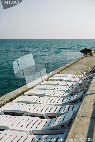 Image of Deckchairs at asphalt coast