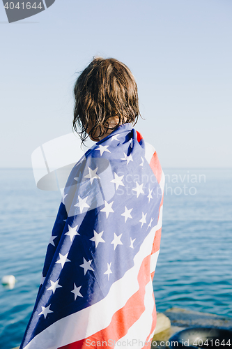 Image of Back view of wet-haired woman in american flag