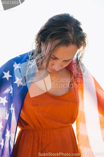 Image of Smiling woman with wet hair and american flag