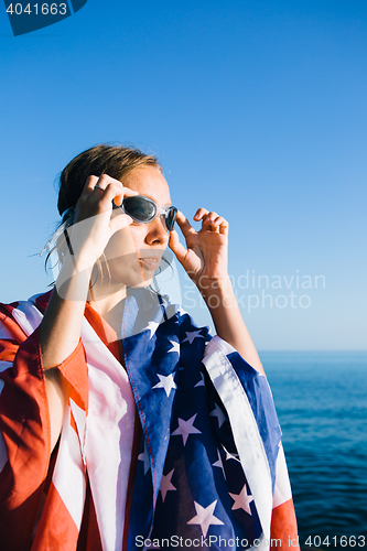 Image of Young woman wearing swimming goggles in sunlight