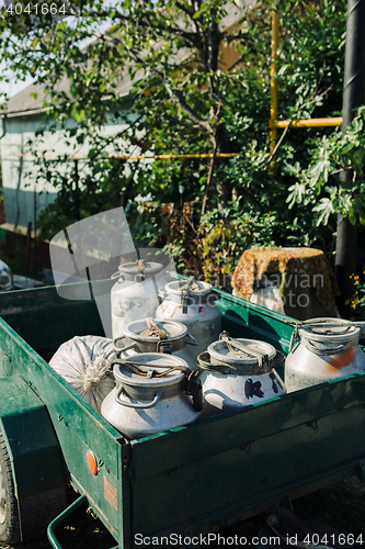 Image of Trailer with cans full of rustic fresh milk