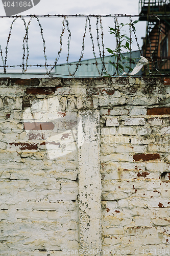 Image of Brick wall with barbed-wire