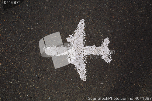 Image of White painted airplane on asphalt