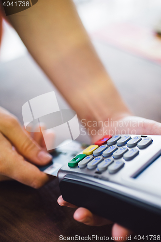 Image of Female hand inserts the credit card into the terminal