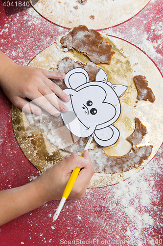 Image of Child making christmas gingerbread