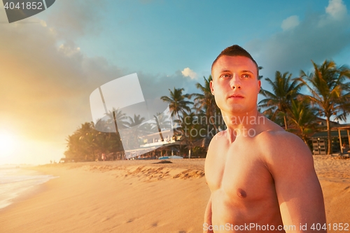 Image of Athletic man on the tropical beach