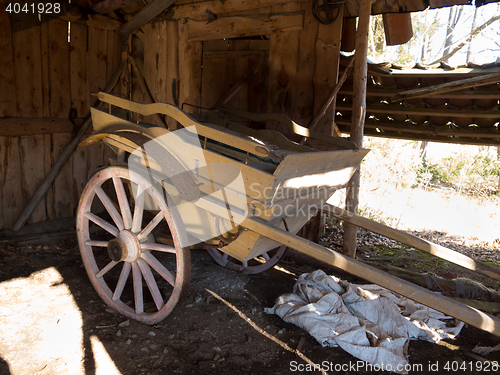 Image of old wooden cart standing in one old barn
