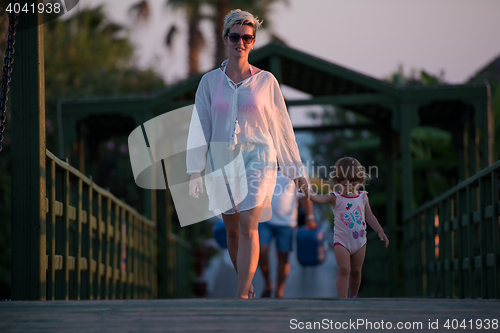 Image of girl and mother walking