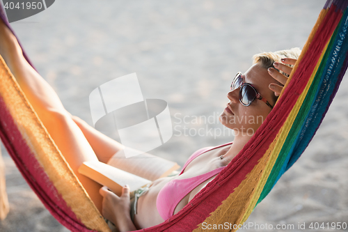 Image of relaxed woman laying in hammock