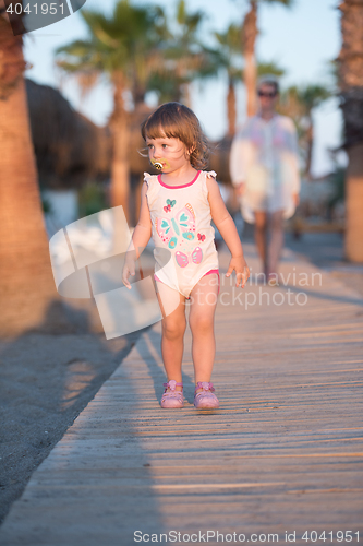 Image of girl and mother walking