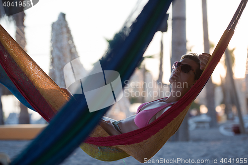 Image of relaxed woman laying in hammock