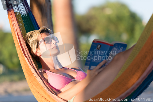 Image of relaxed woman laying in hammock