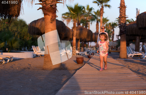 Image of girl and mother walking