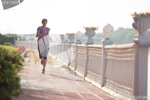 Image of sporty woman jogging