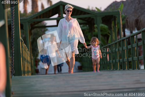 Image of girl and mother walking