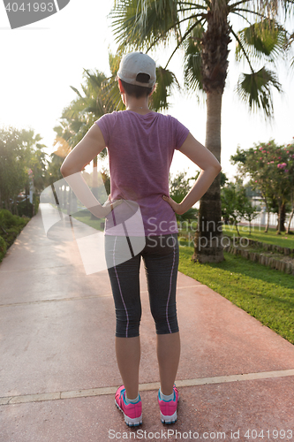 Image of woman  stretching before morning jogging