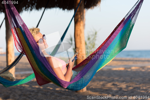 Image of relaxed woman laying in hammock