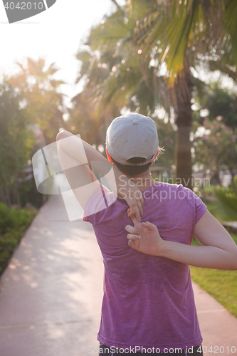 Image of woman  stretching before morning jogging