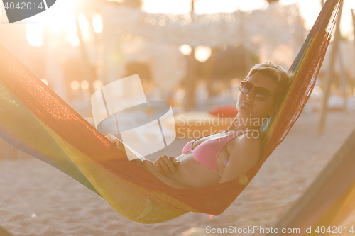 Image of relaxed woman laying in hammock