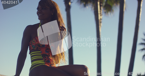 Image of Sexy Woman Wearing Swimsuit Sitting on Bench