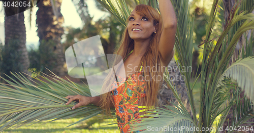 Image of Smiling young woman enjoying a tropical vacation