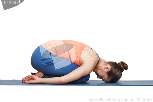 Image of Beautiful sporty fit yogi girl practices yoga asana balasana\r