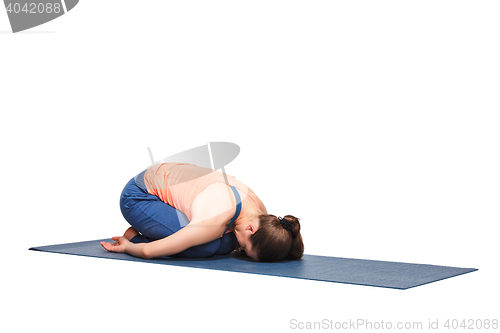 Image of Beautiful sporty fit yogi girl practices yoga asana balasana\r