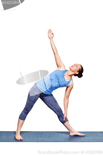 Image of Woman doing yoga asana utthita trikonasana - extended triangle pose