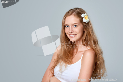 Image of Beautiful young woman with flower in hair