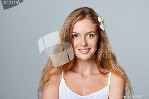 Image of Beautiful young woman with flower in hair