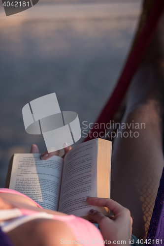 Image of relaxed woman laying in hammock