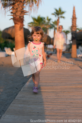 Image of girl and mother walking