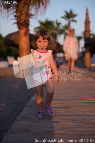 Image of girl and mother walking